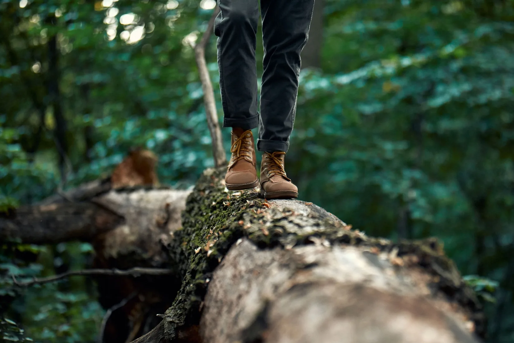 A man walking on a log.