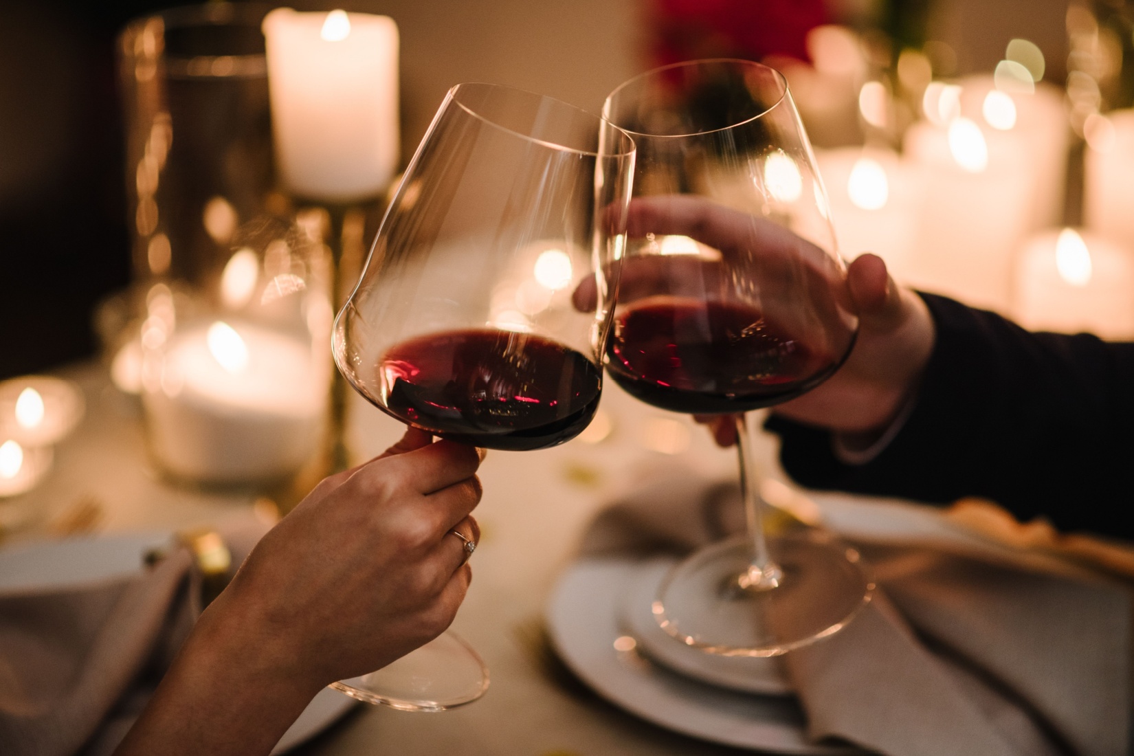 A couple toasting with a glass of wine.