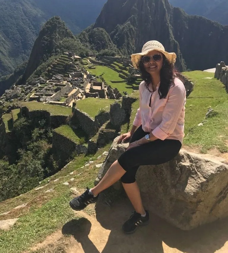 Woman sitting by machu picchu