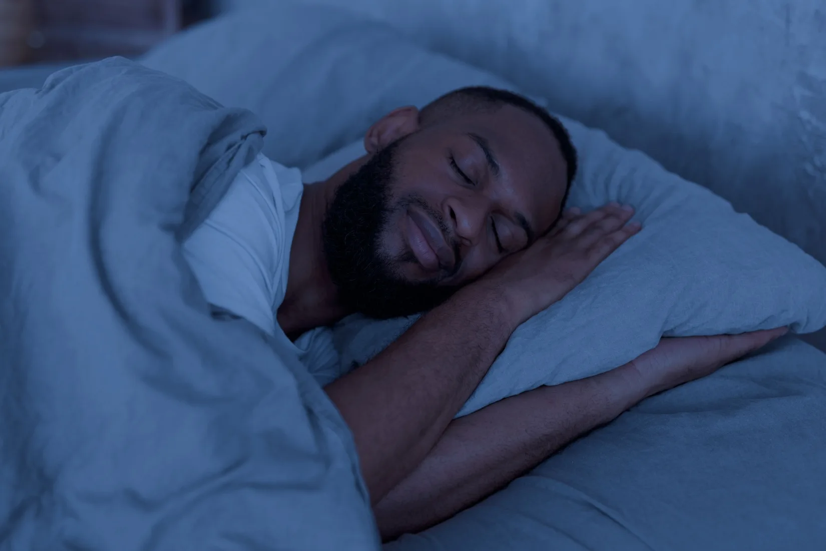 Man asleep in bed.