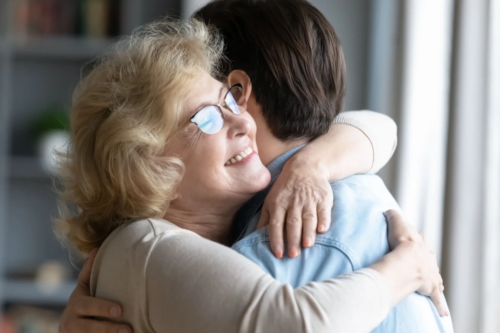 A mother hugging her adult son.