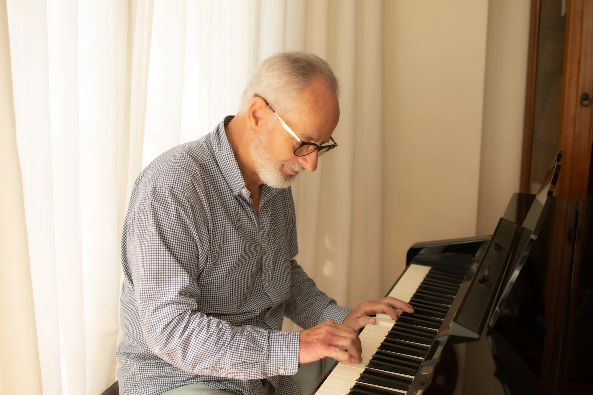 A man practising playing the piano.