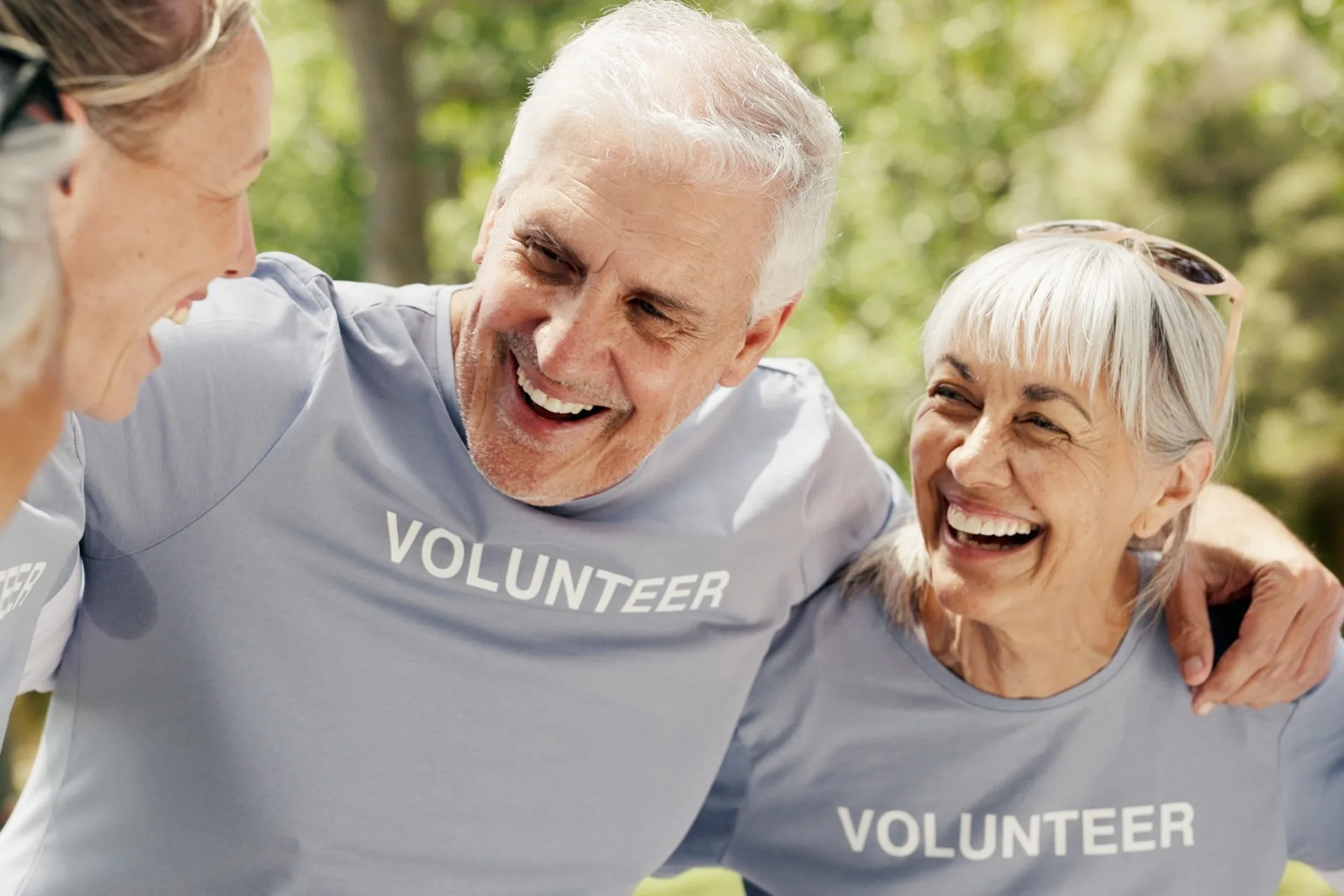 Happy senior people wearing “volunteer” t-shirts