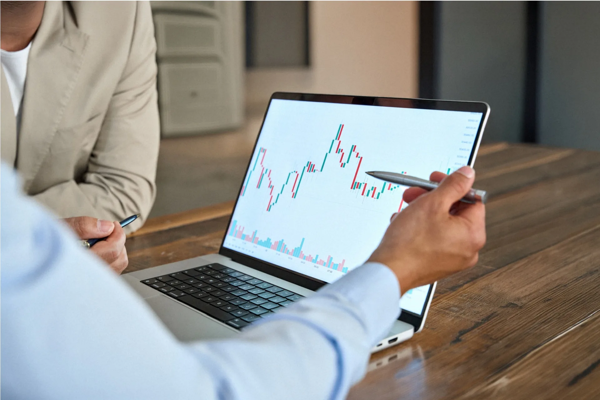 A man reviewing stock market movements on a laptop.